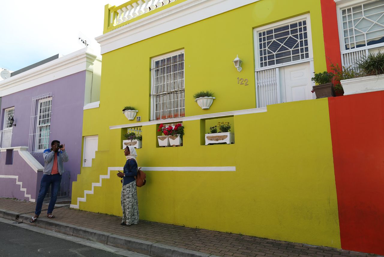 People take photos outside Rashida Emeran's house. 