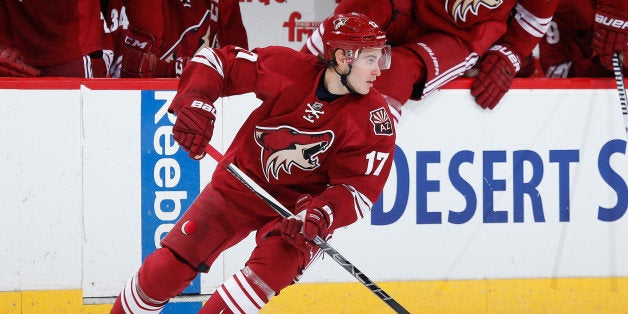 GLENDALE, AZ - APRIL 11: John Moore #17 of the Arizona Coyotes skates with the puck during the NHL game against the Anaheim
