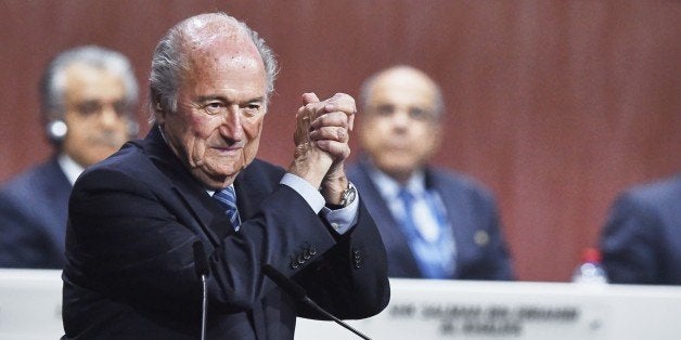 FIFA President Sepp Blatter gestures after being re-elected following a vote to decide on the FIFA presidency in Zurich on May 29, 2015. Sepp Blatter won the FIFA presidency for a fifth time Friday after his challenger Prince Ali bin al Hussein withdrew just before a scheduled second round.AFP PHOTO / MICHAEL BUHOLZER (Photo credit should read MICHAEL BUHOLZER/AFP/Getty Images)