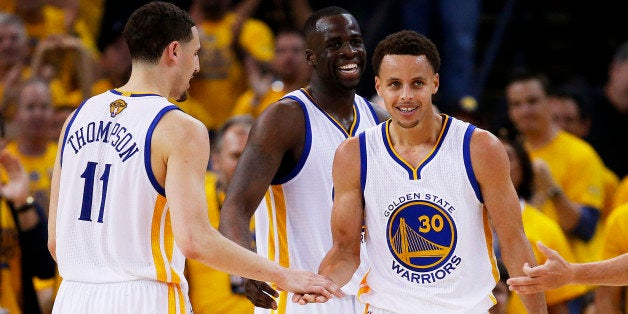OAKLAND, CA - JUNE 14: Stephen Curry #30 Draymond Green #23 and Klay Thompson #11 of the Golden State Warriors celebrate lat