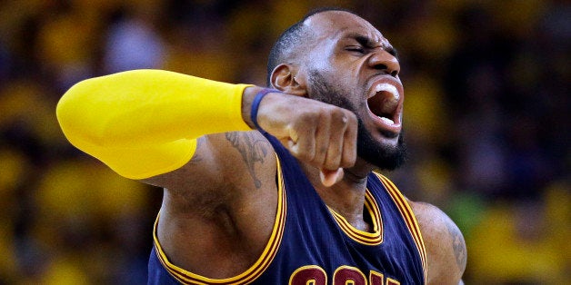 Cleveland Cavaliers forward LeBron James (23) celebrates after end of the overtime period of Game 2 of basketball's NBA Finals against the Golden State Warriors in Oakland, Calif., Sunday, June 7, 2015. The Cavaliers won 95-93 in overtime. (AP Photo/Ben Margot)