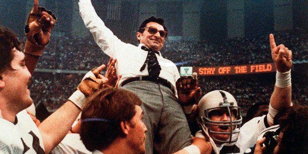 FILE - In this Jan. 1, 1983, file photo, Penn State head football coach Joe Paterno takes a victory ride from his players after defeating Georgia 27-23 in the Sugar Bowl NCAA college football game at the Supderdome in New Orleans, to win the national championship. A proposed settlement, announced Friday, Jan. 16, 2015, by the NCAA, will give Penn State back 112 football team wins that were vacated two years ago in the Jerry Sandusky child molestation scandal. If approved, the new agreement also would restore former coach Paterno's status as the winningest coach in major college football history with 409 victories. (AP Photo/File)