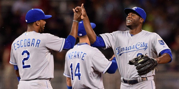 MINNEAPOLIS, MN - JUNE 10: Alcides Escobar #2, Omar Infante #14 and Lorenzo Cain #6 of the Kansas City Royals celebrate a win
