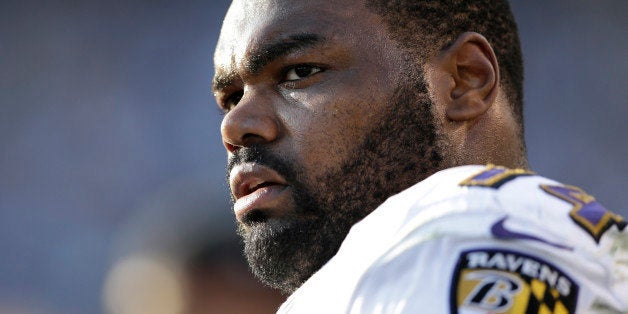 In this Nov. 25, 2012 photo, Baltimore Ravens tackle Michael Oher sits on the sidelines during the second half of an NFL football game against the San Diego Chargers, in San Diego. Oher and his adoptive family were depicted in the book and movie, "The Blind Side." Oher will play in his first Super Bowl on Sunday, Feb. 3, 2013, in New Orleans, which is where his adoptive father grew up and went to high school with author Michael Lewis, who wrote "The Blind Side." (AP Photo/Gregory Bull)