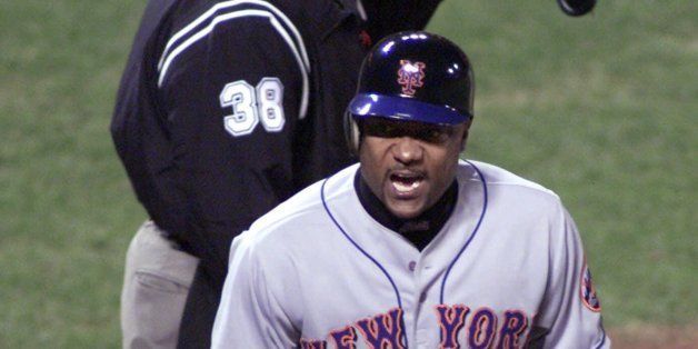 New York Mets' Darryl Hamilton reacts after scoring the winning run in the tenth inning on a single by teammate Jay Payton against the San Francisco Giants Thursday, Oct. 5, 2000, in San Francisco. At left is home plate umpire Gary Cederstrom. The Mets won the game, 5-4 in 10 innings. (AP Photo/Eric Risberg)