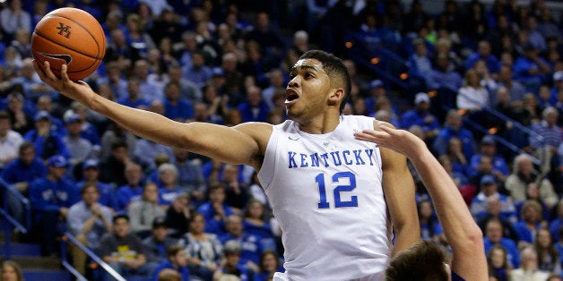 Kentucky's Karl-Anthony Towns (12) shoots next to Grand Canyon's Matt Jackson, right, and during the first half of an NCAA co