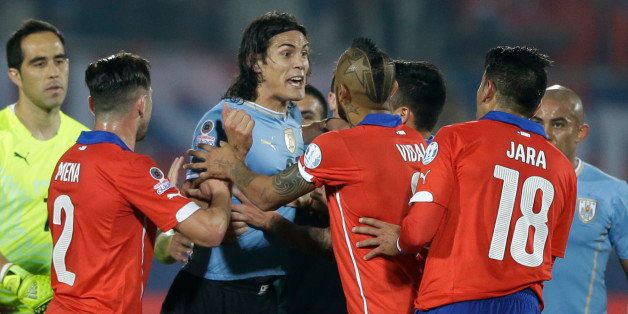 Uruguay's Edinson Cavani, center left, argues with Chile's Gonzalo Jara, 2nd right, during a Copa America quarterfinal soccer match at the National Stadium in Santiago, Chile, Wednesday, June 24, 2015. Cavani was expelled from the game after receiving a double yellow card. Chile won the match 1-0 (AP Photo/Ricardo Mazalan)