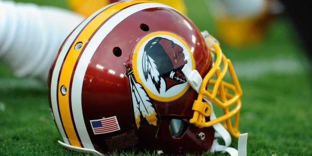 LANDOVER, MD - AUGUST 18: A Washington Redskins helmet sits on the grass during a preseason football game between the Redskins and Cleveland Browns at FedExField on August 18, 2014 in Landover, Maryland. (Photo by TJ Root/Getty Images)