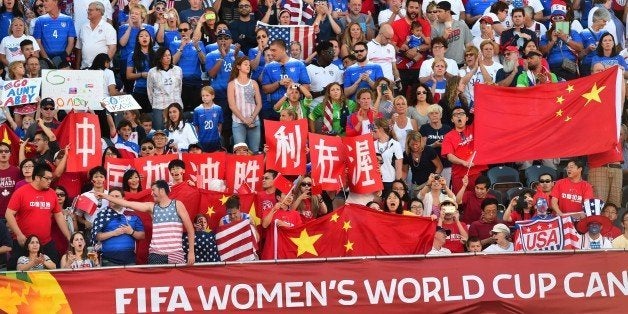 Fans of China and the US cheer before their 2015 FIFA Women's World Cup quarterfinal match between the US and China at Lansdowne Stadium in Ottawa, Ontario on June 26, 2015. AFP PHOTO/NICHOLAS KAMM (Photo credit should read NICHOLAS KAMM/AFP/Getty Images)