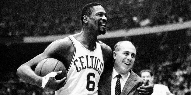 FILE - In this Dec. 12, 1964 file photo, Boston Celtics' Bill Russell, left, is congratulated by coach Arnold "Red" Auerbach after scoring his 10,000th career point during a basketball game against the Baltimore Bullets at the Boston Garden in Boston. As a coach, Red Auerbach got the most out of Bill Russell as a player not by yelling at him, or teaching him new techniques. He just talked to him man-to-man. Russell celebrates their relationship in a new book about Auerbach. (AP Photo/file)