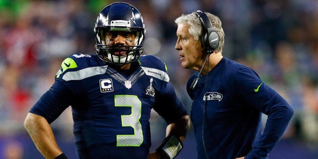 GLENDALE, AZ - FEBRUARY 01: Head coach Pete Carroll of the Seattle Seahawks talks to Russell Wilson #3 of the Seattle Seahaw