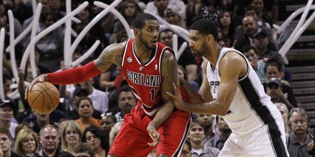 SAN ANTONIO, TX - MAY 14: LaMarcus Aldridge #12 of the Portland Trail Blazers attempts to drive around Tim Duncan #21 of the San Antonio Spurs in Game Five of the Western Conference Semifinals during the 2014 NBA Playoffs at the AT&T Center on May 14, 2014 in San Antonio, Texas. NOTE TO USER: User expressly acknowledges and agrees that, by downloading and/or using this photograph, user is consenting to the terms and conditions of the Getty Images License Agreement. (Photo by Chris Covatta/Getty Images)
