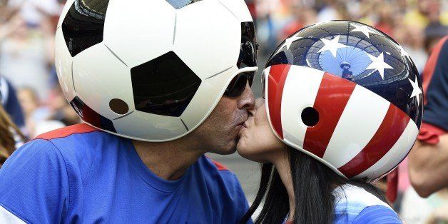 USA supporters kiss ahead the final football match between USA and Japan during their 2015 FIFA Women's World Cup at the BC Place Stadium in Vancouver on July 5, 2015. AFP PHOTO / FRANCK FIFE (Photo credit should read FRANCK FIFE/AFP/Getty Images)