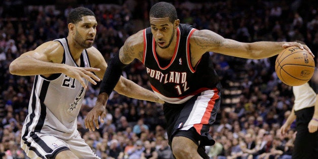 Portland Trail Blazers' LaMarcus Aldridge (12) drives around San Antonio Spurs' Tim Duncan (21) during the second half on an NBA basketball game, Friday, Jan. 17, 2014, in San Antonio. Portland won 109-100. (AP Photo/Eric Gay)