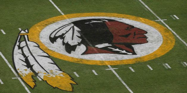 In this photo taken Aug. 7, 2014, the Washington Redskins logo is seen on the field before an NFL football preseason game against the New England Patriots in Landover, Md. Lawyers for the Washington Redskins are telling a judge that the team's free-speech rights are being infringed by a federal panel's decision to cancel the team's trademarks for being disparaging to Native Americans. (AP Photo/Alex Brandon)