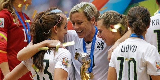 United States' Abby Wambach, center, celebrates with teammates after the U.S. beat Japan 5-2 in the FIFA Women's World Cup soccer championship in Vancouver, British Columbia, Canada, Sunday, July 5, 2015. (AP Photo/Elaine Thompson)