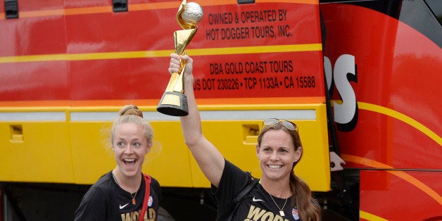 LOS ANGELES, CA - JULY 6: Captain Christie Rampone (R) holds the FIFA Women's World Cup trophy as she walks to the bus with teammate Becky Sauerbrunn after they arrived at Los Angeles International Airport July 6, 2015 in Los Angeles, California. (Photo by Kevork Djansezian/Getty Images)