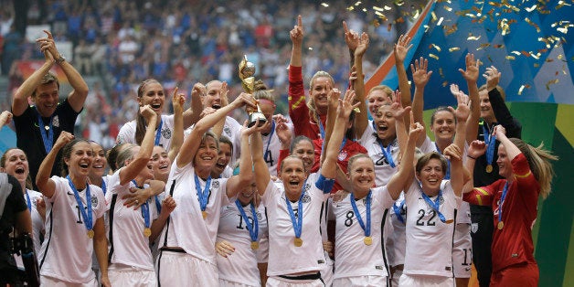 The United States Women's National Team celebrates with the trophy after they beat Japan 5-2 in the FIFA Women's World Cup soccer championship in Vancouver, British Columbia, Canada, Sunday, July 5, 2015. (AP Photo/Elaine Thompson)