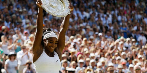 Serena Williams of the United States holds up the trophy after winning the women's singles final against Garbine Muguruza of Spain, at the All England Lawn Tennis Championships in Wimbledon, London, Saturday July 11, 2015. (AP Photo/Kirsty Wigglesworth)