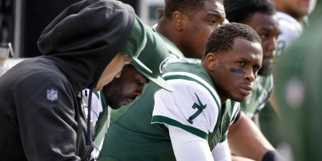 FILE - In this Oct. 26, 2014, file photo, New York Jets quarterback Geno Smith sits on the bench during the first half of an