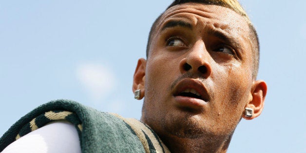 Nick Kyrgios of Australia walks off court after defeating Juan Monaco of Argentina during their singles match at the All England Lawn Tennis Championships in Wimbledon, London, Wednesday July 1, 2015. Kyrgios won 7-6, 6-3, 6-4. (AP Photo/Kirsty Wigglesworth)