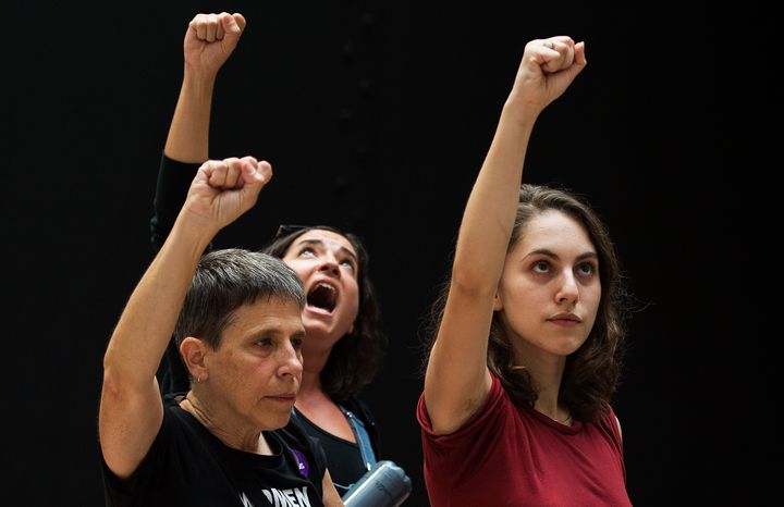 Detained protesters gesture at the Senate Hart building during a rally against Supreme Court nominee Brett Kavanaugh on Capitol Hill in Washington, D.C., on Oct. 4, 2018.