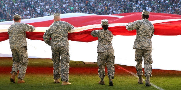 PHILADELPHIA, PA - SEPTEMBER 20: A giant flag covers the field as the national anthem is sung before the game between the Philadelphia Eagles and the Dallas Cowboys on September 20, 2014 at Lincoln Financial Field in Philadelphia, Pennsylvania. (Photo by Elsa/Getty Images)