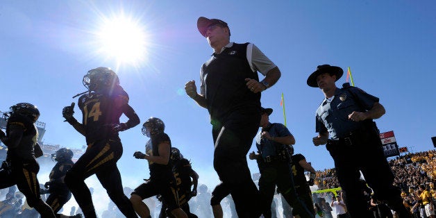 COLUMBIA , MO - SEPTEMBER 19: Missouri Tigers head coach Gary Pinkel runs onto the field with his team prior to a game against the Connecticut Huskies in the first quarter at Memorial Stadium on September 19, 2015 in Columbia, Missouri. (Photo by Ed Zurga/Getty Images)