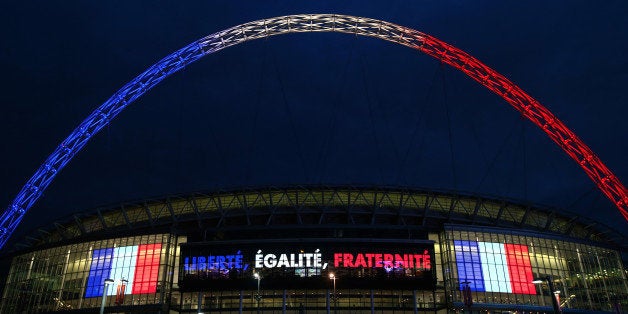 LONDON, ENGLAND - NOVEMBER 16: Wembley stadium is lit up in the French Tricolore in remembrance to the victims of last weeks terror attacks in Paris prior to the France training session at Wembley Stadium on November 16, 2015 in London, England. (Photo by Clive Rose/Getty Images)