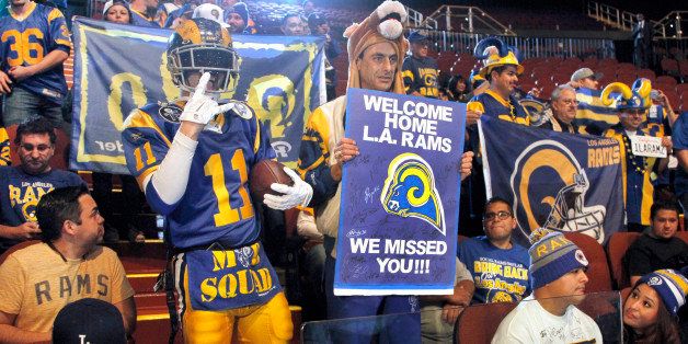 Rams fans cheer for the NFL football team at a news conference at the Forum in Inglewood, Calif., on Friday, Jan. 15, 2016. The St. Louis Rams are returning to play in 2016 in the Los Angeles area; in a few years the team will begin play at a stadium being built near the Forum. (AP Photo/Nick Ut)