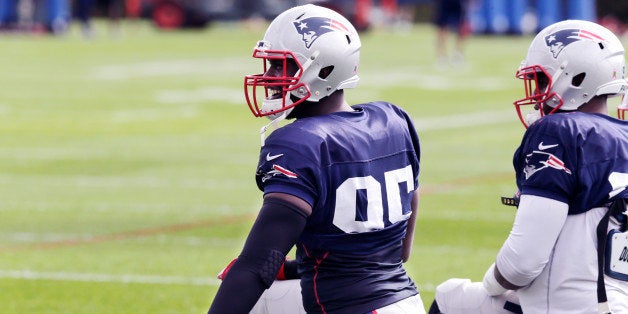 New England Patriots defensive end Chandler Jones stretches during an NFL football practice in Foxborough, Mass., Wednesday, Oct. 14, 2015. The Patriots face the Indianapolis Colts on Sunday. (AP Photo/Charles Krupa)