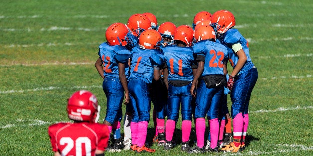 UNITED STATES - 2015/10/11: Young boys in the huddle during a Pop Warner football game. (Photo by John Greim/LightRocket via Getty Images)