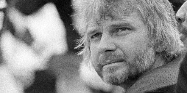 Oakland Raiders quarterback Ken Stabler (12) sits on the sidelines during first half of their Hall of Fame game with the Dallas Cowboys in Canton, Ohio, July 28, 1979. At right is defensive tackle Otis Sistrunk.(AP Photo)