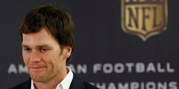 New England Patriots quarterback Tom Brady listens to a question during a press conference following the NFL football AFC Cha