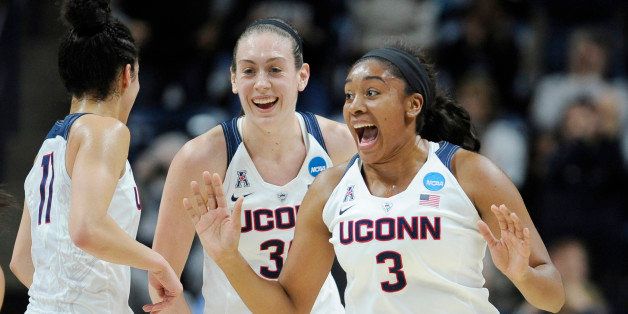 Connecticut's Morgan Tuck, right, celebrates with Kia Nurse, left, and Breanna Stewart, rear, after sinking a basket during the first half of a second round women's college basketball game against Duquesne in the NCAA Tournament, Monday, March 21, 2016, in Storrs, Conn. (AP Photo/Jessica Hill)