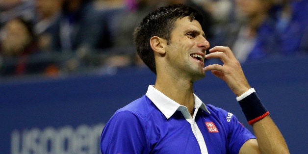 Novak Djokovic, of Serbia, reacts after losing a point to Roger Federer, of Switzerland, during the men's championship match