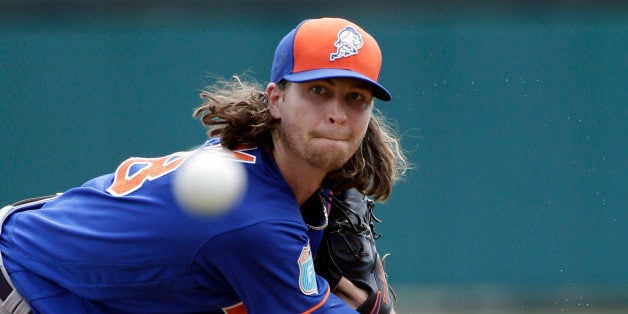 New York Mets starting pitcher Jacob deGrom throws against the Atlanta Braves in the first inning of a spring training baseba
