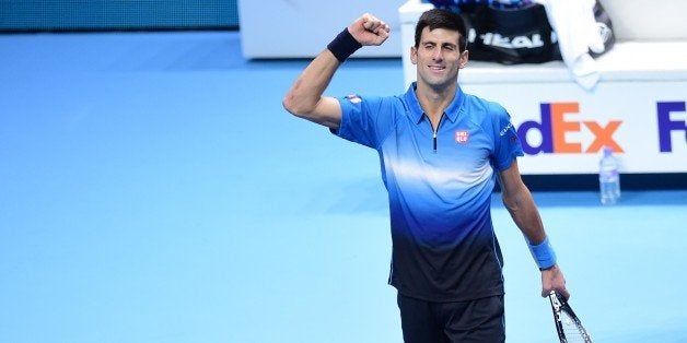 Serbia's Novak Djokovic celebrates after winning the men's singles final match against Switzerland's Roger Federer on day eight of the ATP World Tour Finals tennis tournament in London on November 22, 2015. AFP PHOTO / LEON NEAL (Photo credit should read LEON NEAL/AFP/Getty Images)