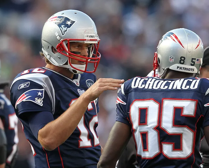 New England Patriots Tom Brady (12) and Chad Ochocinco stand in the huddle  in the second quarter against the New York Jets in week 10 of the NFL  season at MetLife Stadium