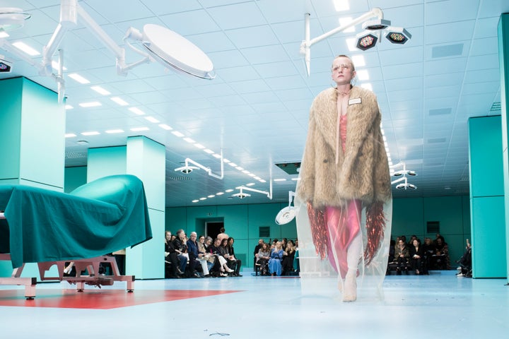 A model wears a faux fur coat on the runway at Gucci's fall/winter 2018 show.