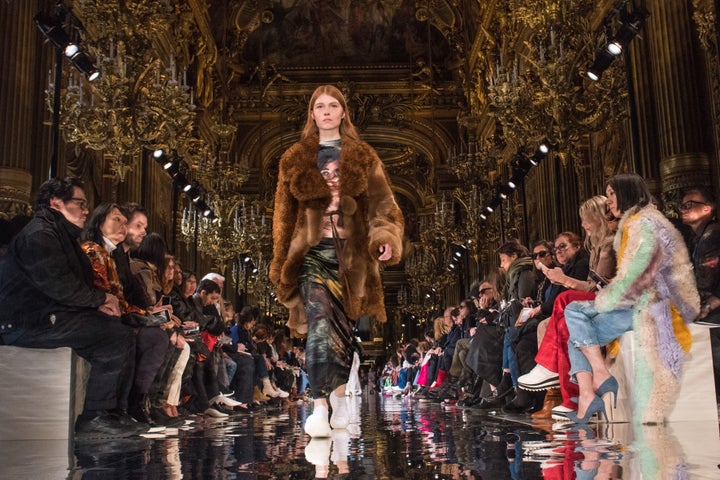 A model wears a faux fur coat on the runway at Stella McCartney's fall/winter 2018 show.