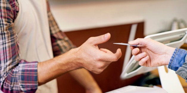 Cropped shot of a customer paying at a cafe with a credit card