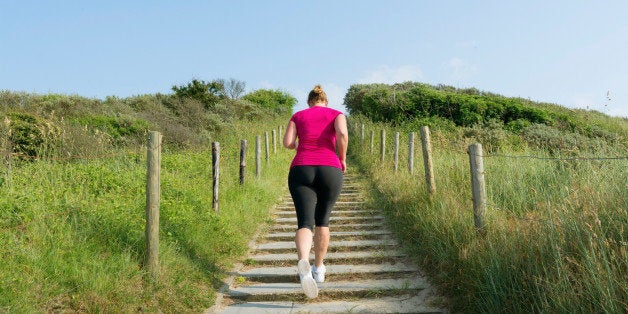 Rear view of woman running up stairs