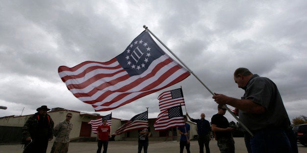 Anti-Muslim protestor gather across the street from a mosque in Richardson, Texas, Dec. 12, 2015. (AP Photo/LM Otero)