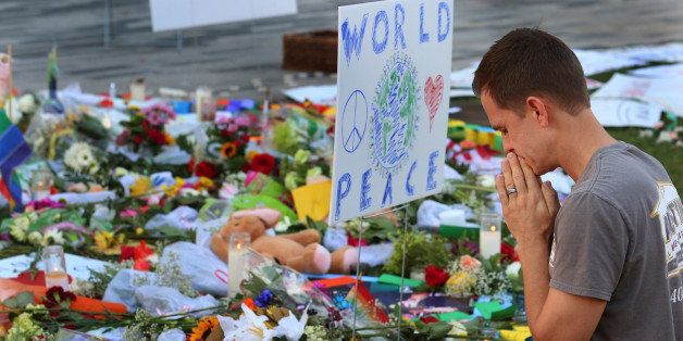 Matt Mitchell, 42, who was born and raised in Orlando, takes a moment Tuesday, June 14, 2016 to pray at a growing memorial at the The Dr. Phillips Center for the victims of the mass shooting Sunday at the Pulse Nightclub in Orlando. (Red Huber/Orlando Sentinel/TNS via Getty Images)