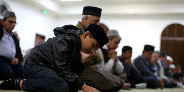 CHINO, CA - DECEMBER 03: A Muslim boy prays in the mosque during a prayer vigil at Baitul Hameed Mosque on December 3, 2015