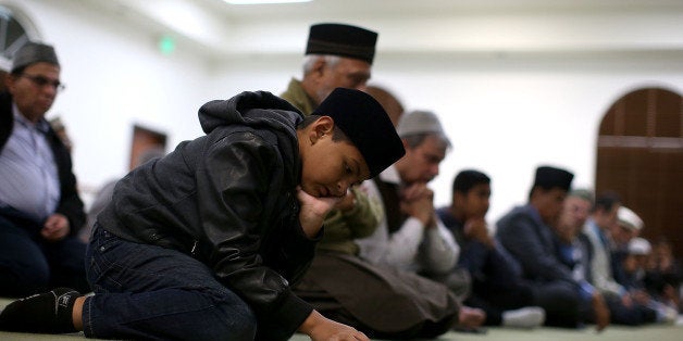 CHINO, CA - DECEMBER 03: A Muslim boy prays in the mosque during a prayer vigil at Baitul Hameed Mosque on December 3, 2015 in Chino, California. The San Bernardino community is mourning as police continue to investigate a mass shooting at the Inland Regional Center in San Bernardino that left at least 14 people dead and another 21 injured. (Photo by Justin Sullivan/Getty Images)