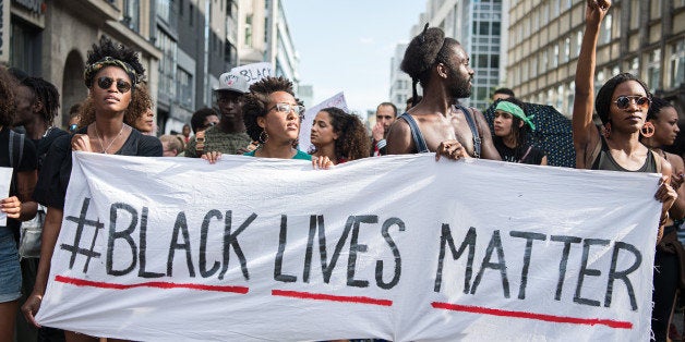 Protestors hold a banner reading 'Black Lives Matter' during a demonstration in Berlin, on July 10, 2016 with the motto 'Black Lives Matter - No Justice = No Peace' as protest over the deaths of two black men at the hands of police last week. / AFP / dpa / Wolfram Kastl / Germany OUT (Photo credit should read WOLFRAM KASTL/AFP/Getty Images)