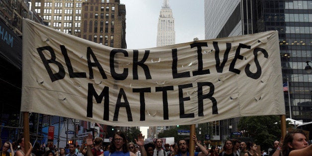 People take part in a protest against the killings of Alton Sterling and Philando Castile during a march through Manhattan, with the Empire State Building seen in the background, in New York July 7, 2016. REUTERS/Darren Ornitz