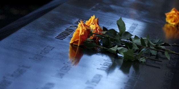 Flowers are seen on the reflecting pool of the 911 Memorial during a commemoration ceremony marking the 23rd anniversary of t